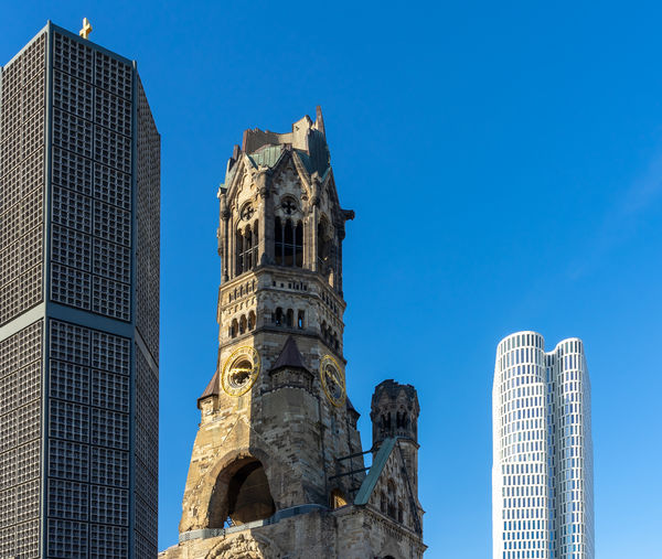 Low angle view of buildings against blue sky