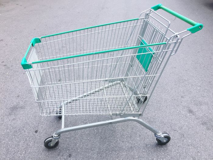 Empty shopping cart on road