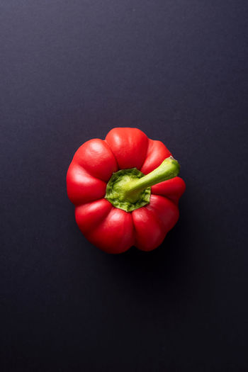 Directly above shot of red bell peppers against black background