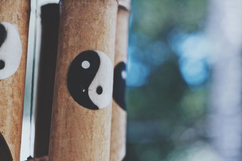 Close up of yin yang symbol on wood