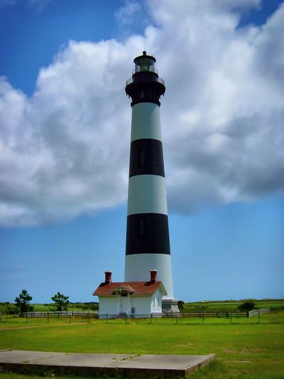 Lighthouse against cloudy sky