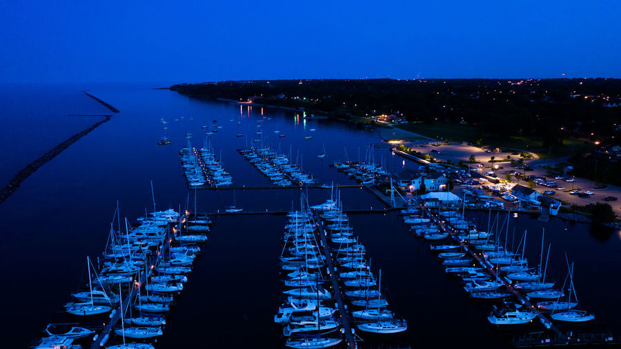 High angle view of illuminated boats in sea at night