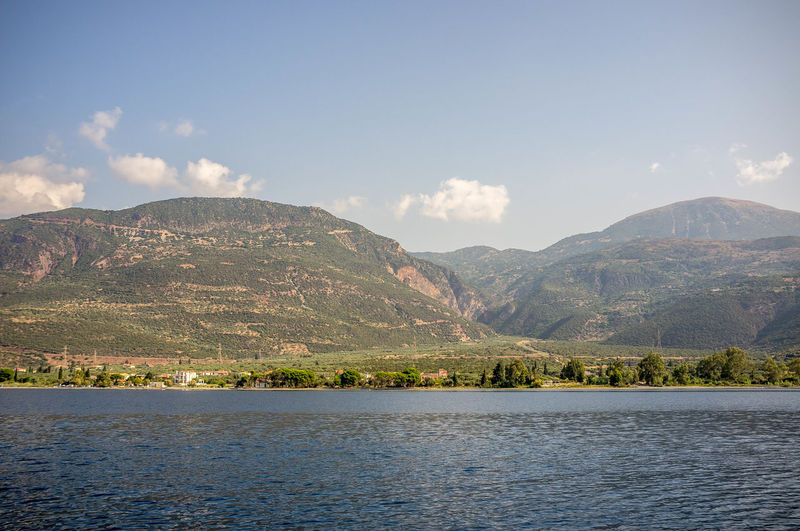 Scenic view of lake by mountains against sky