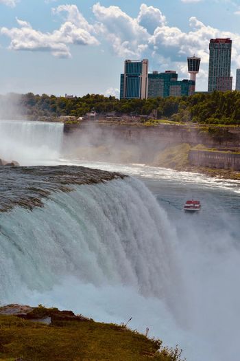 Scenic view of waterfall against sky