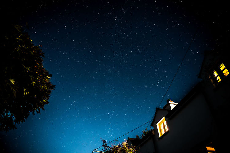 Stary sky above rural british cottage 