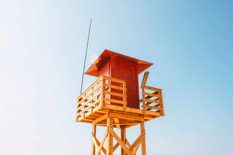 Low angle view of a lifeguard hut against blue sky