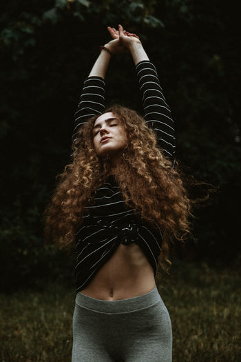 Portrait of beautiful young woman standing in water