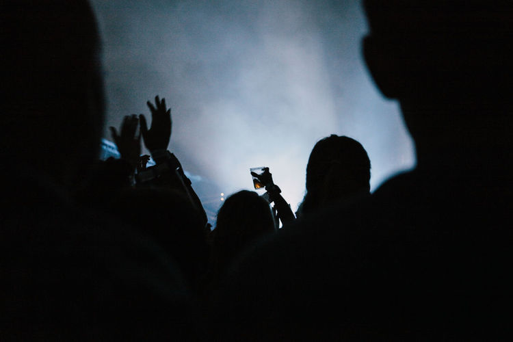 Silhouette of people at music concert