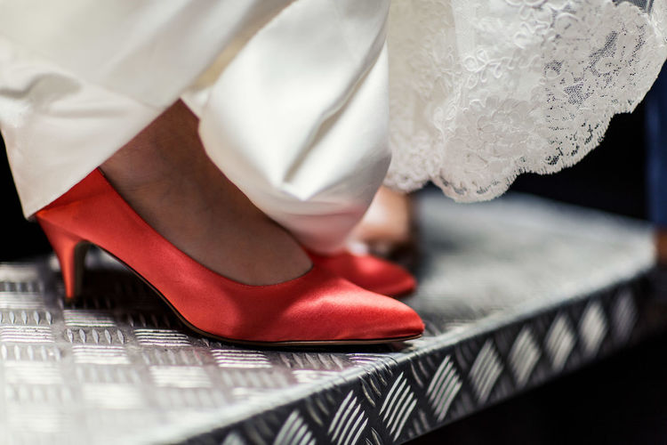 Close-up of high heels and wedding dress