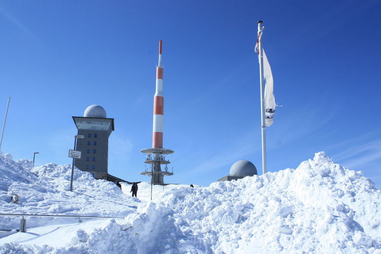 Weather station on snow covered field at harz national park against sky