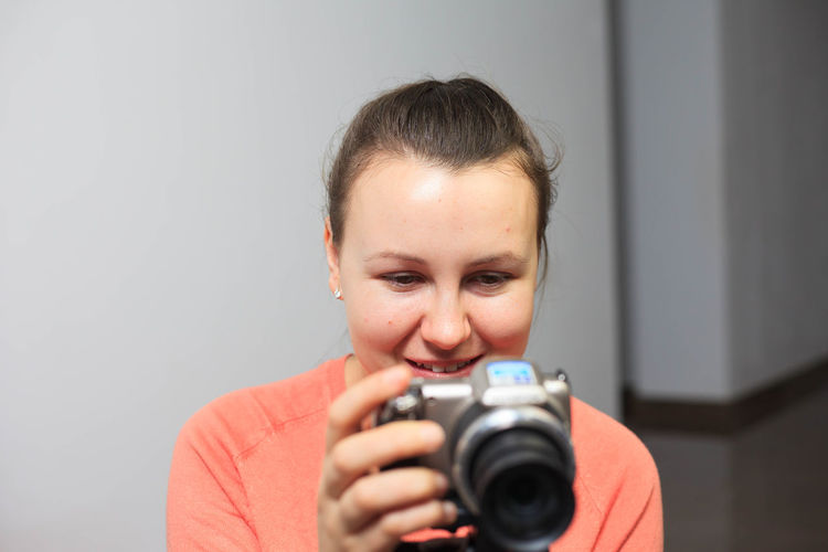 Portrait of smiling girl holding camera
