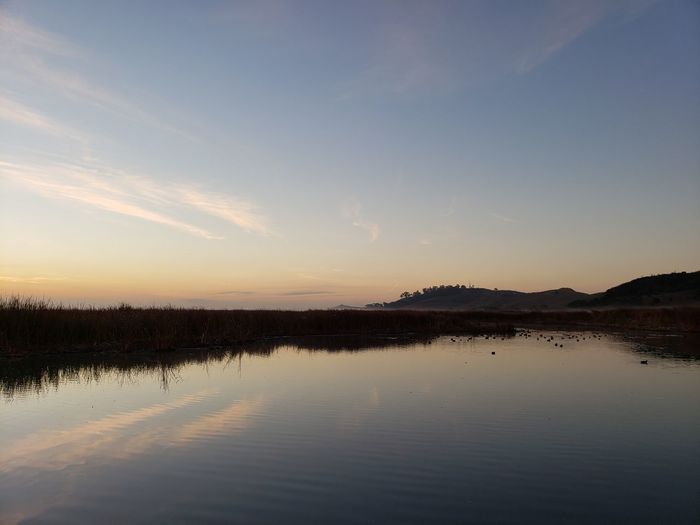 Scenic view of lake against sky during sunset