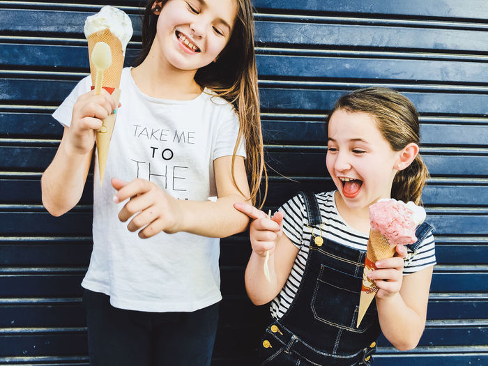Portrait of smiling friends holding ice cream