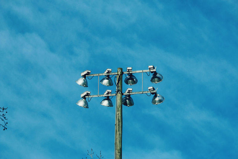 Low angle view of street lights against sky