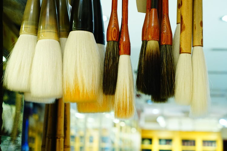 Close-up of paintbrushes in shop for sale