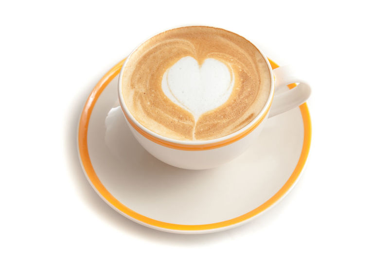 Coffee cup with heart shape over white background