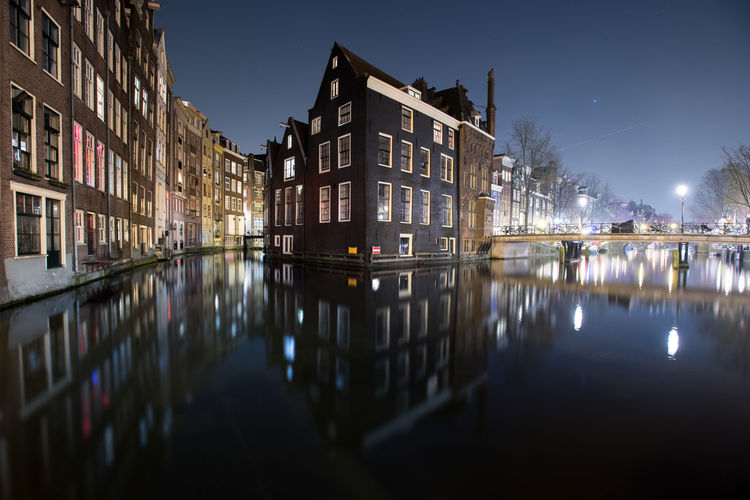 Canal in city at night