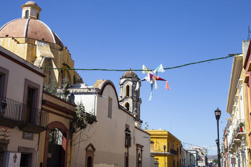 Mexican piñata hanging over colonial street of oaxaca, mexico