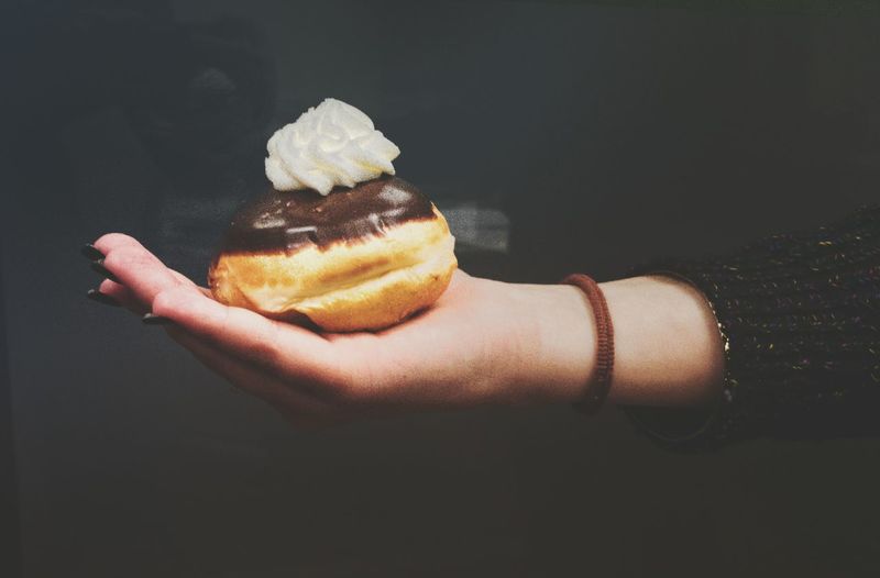 Close-up of hand holding donut