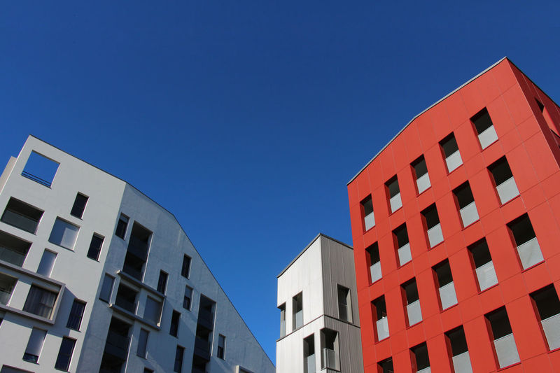 Low angle view of residential buildings against clear blue sky
