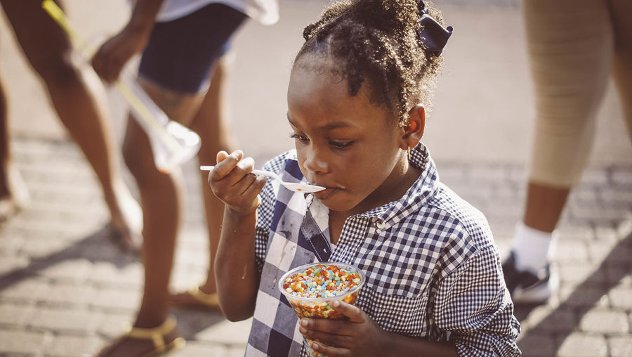 Girl eating ice cream outdoors