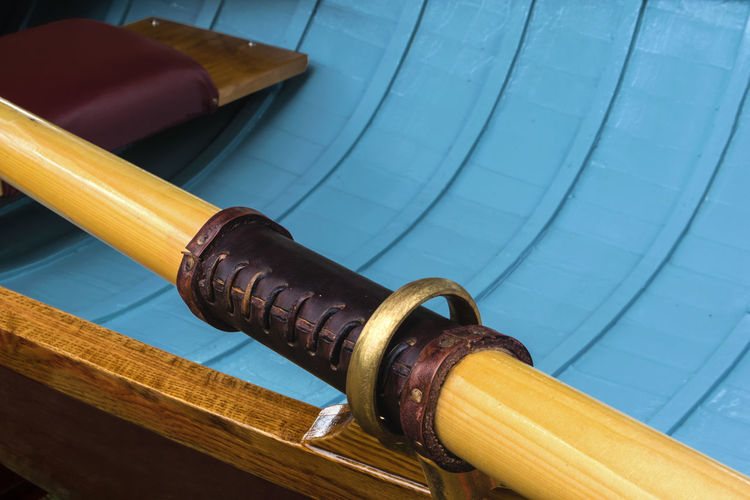 Close-up of oar on vintage wooden canoe