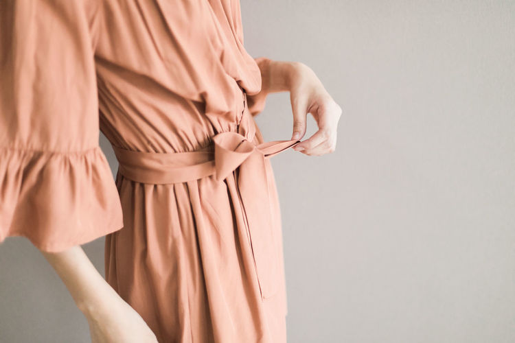 Rear view of woman standing against white background