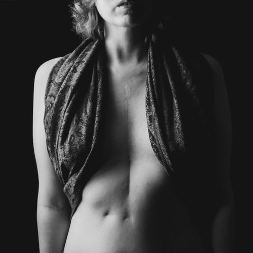 Midsection of woman against black background