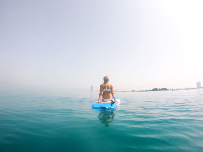 Woman sitting on the paddle board with a view on burj al arab