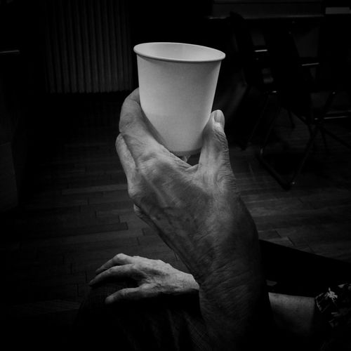 Cropped image of hand holding disposable cup