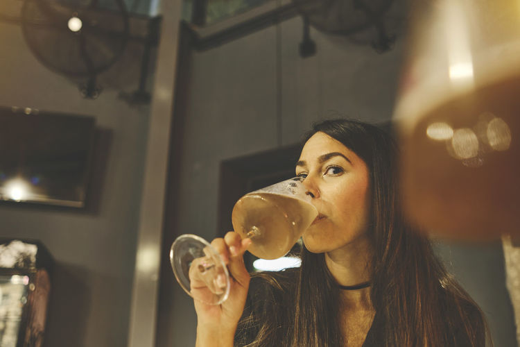 Leisure, drinks, degustation, people and holidays concept, close up of smiling woman