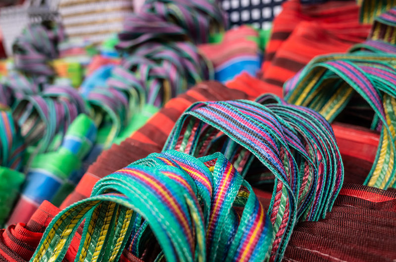 Close-up of multi colored bags for sale in market