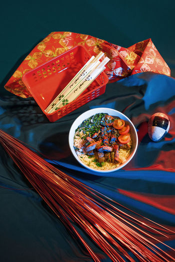 High angle view of food in bowl by fabric and decoration on table