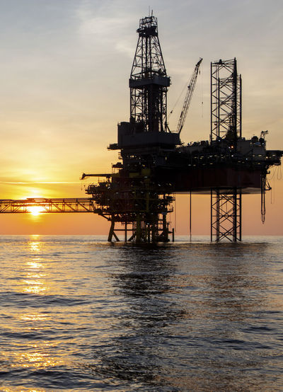 Offshore gas production platform at sunset