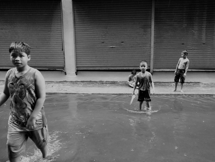 Full length of boy standing in water