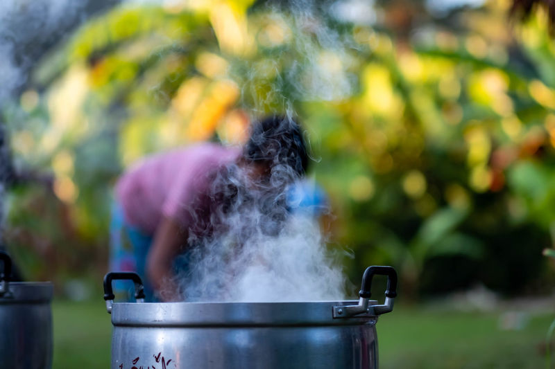 Midsection of woman preparing food in yard
