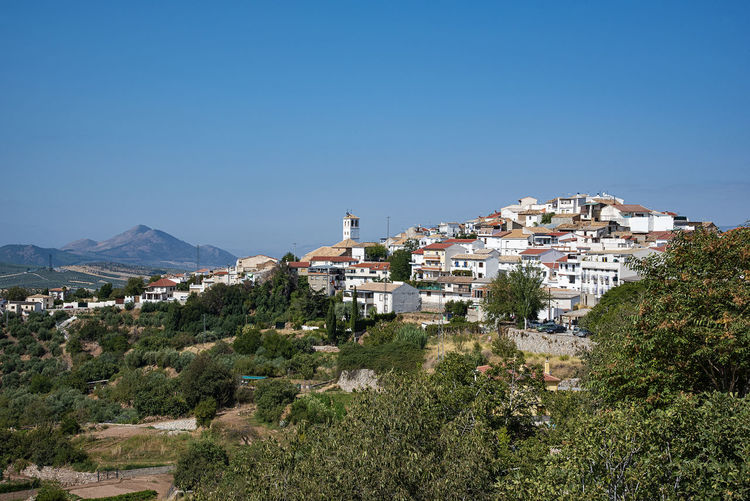 View of townscape against clear blue sky