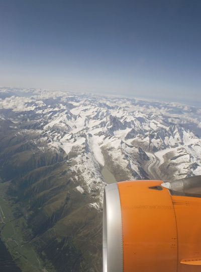 Aerial view of mountains against sky during winter