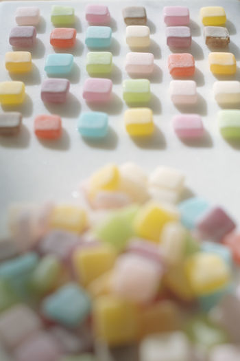 High angle view of multi colored candies in row