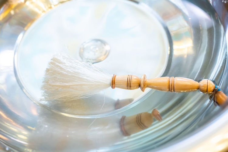 Brush floating on holy water in bowl