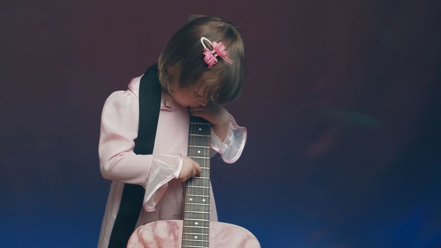Side view of boy playing guitar