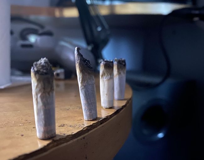 Close-up of burned marijuana joint on table