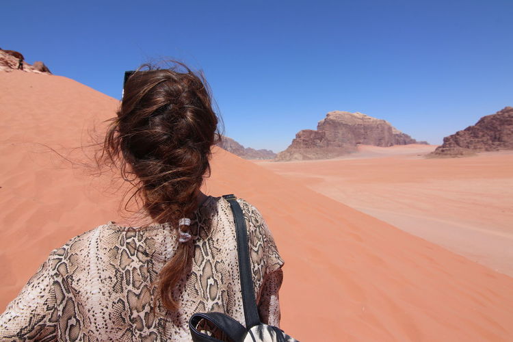 Woman with braided hair walking in the wadi rum desert