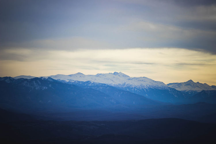 Scenic view of snowcapped mountains against sky