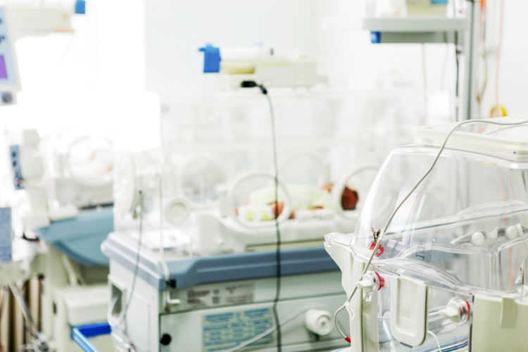 Newborn baby in hospital incubator