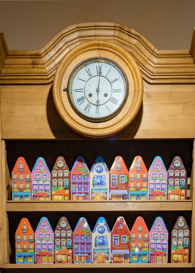 Toy house on shelf with clock