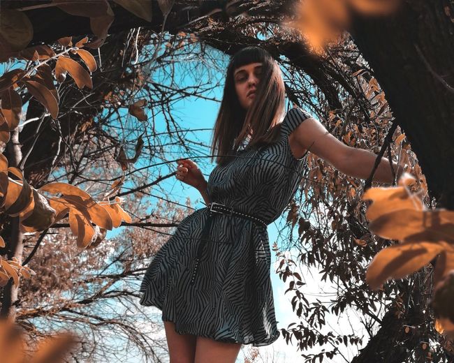 Portrait of woman against tree