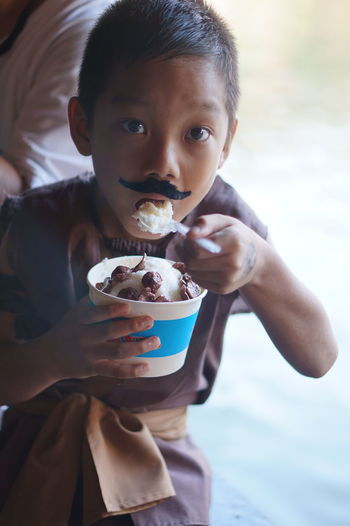 Portrait of man eating ice cream