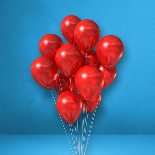 Close-up of red balloons against blue background