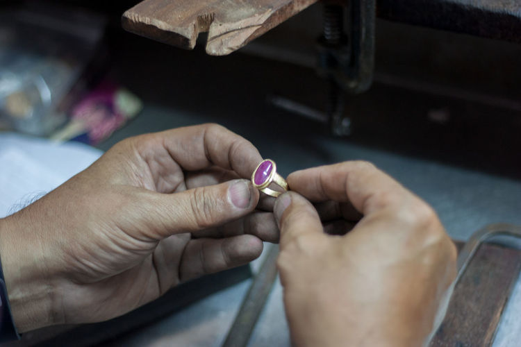 Cropped image of jeweler shaping ring in workshop